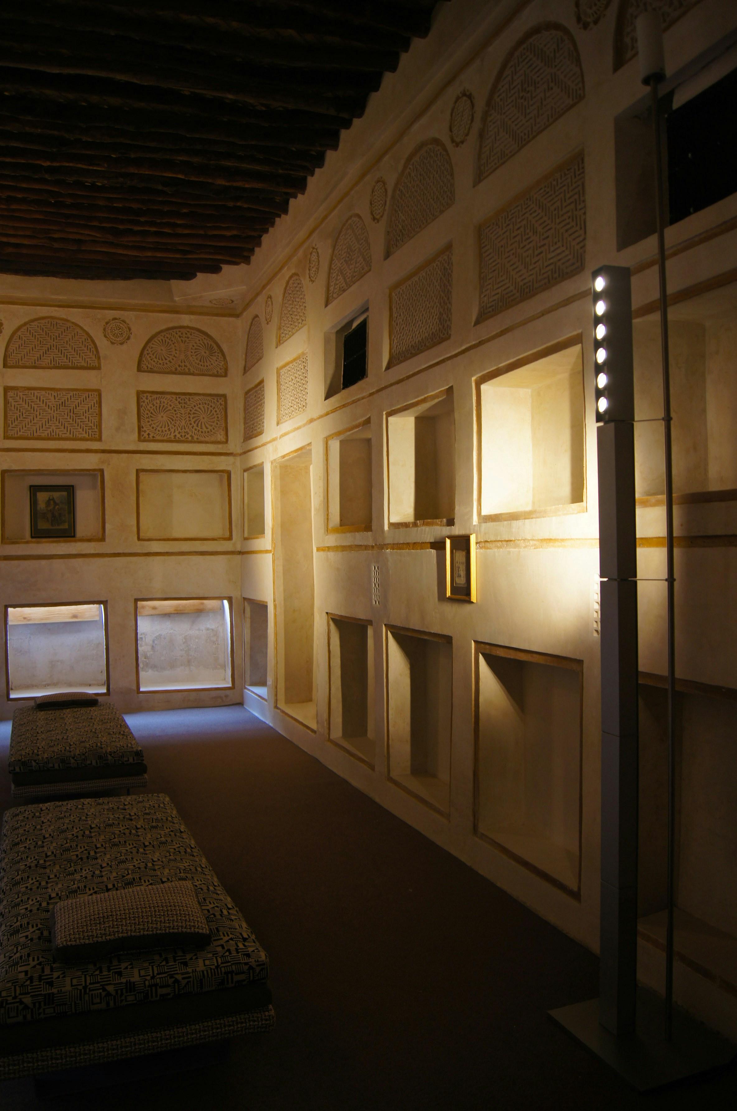 Traditional university lecture hall with wooden benches and ornate ceiling
