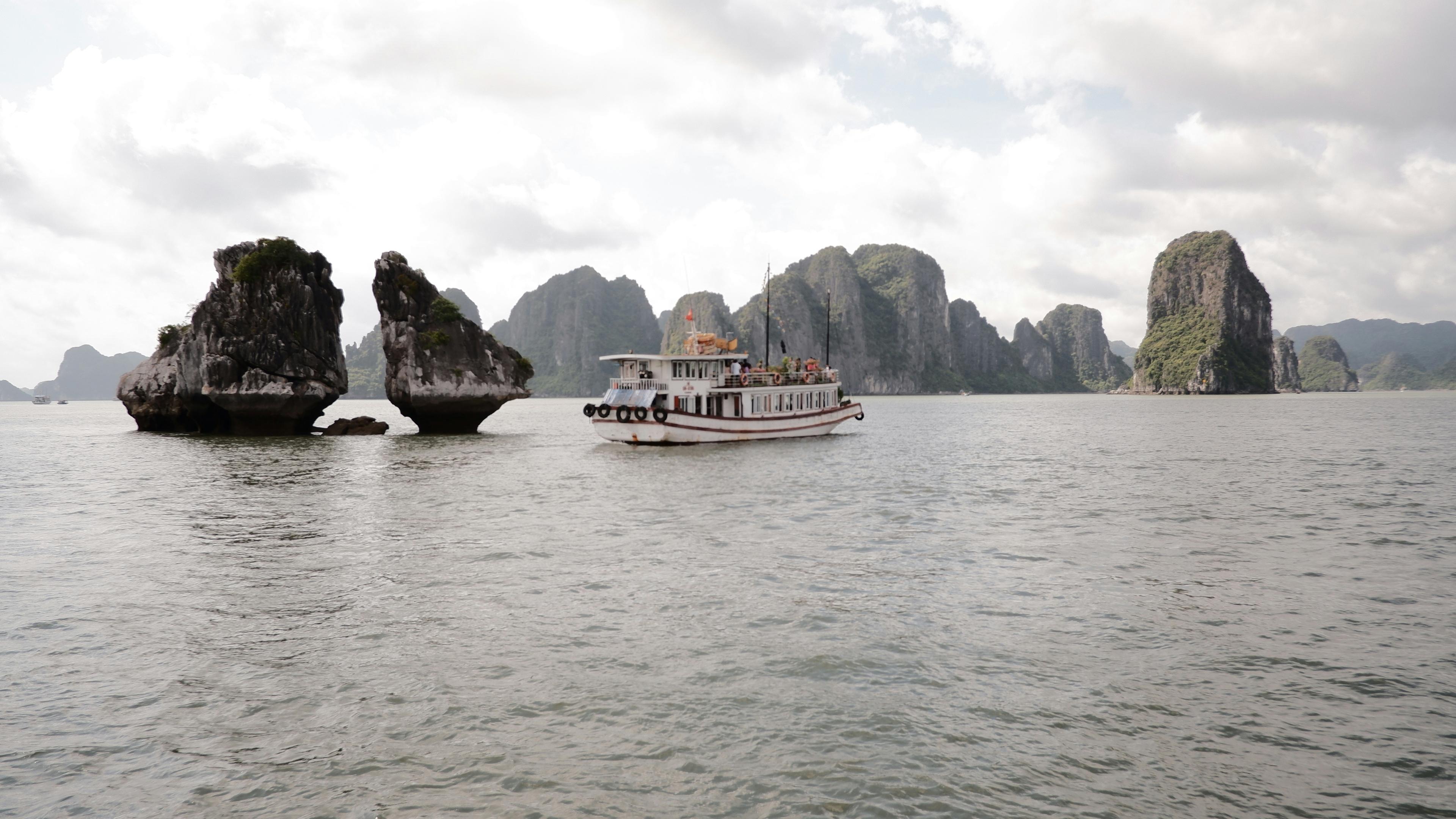 Ha Long Bay in Vietnam with limestone karsts and emerald waters with traditional boats
