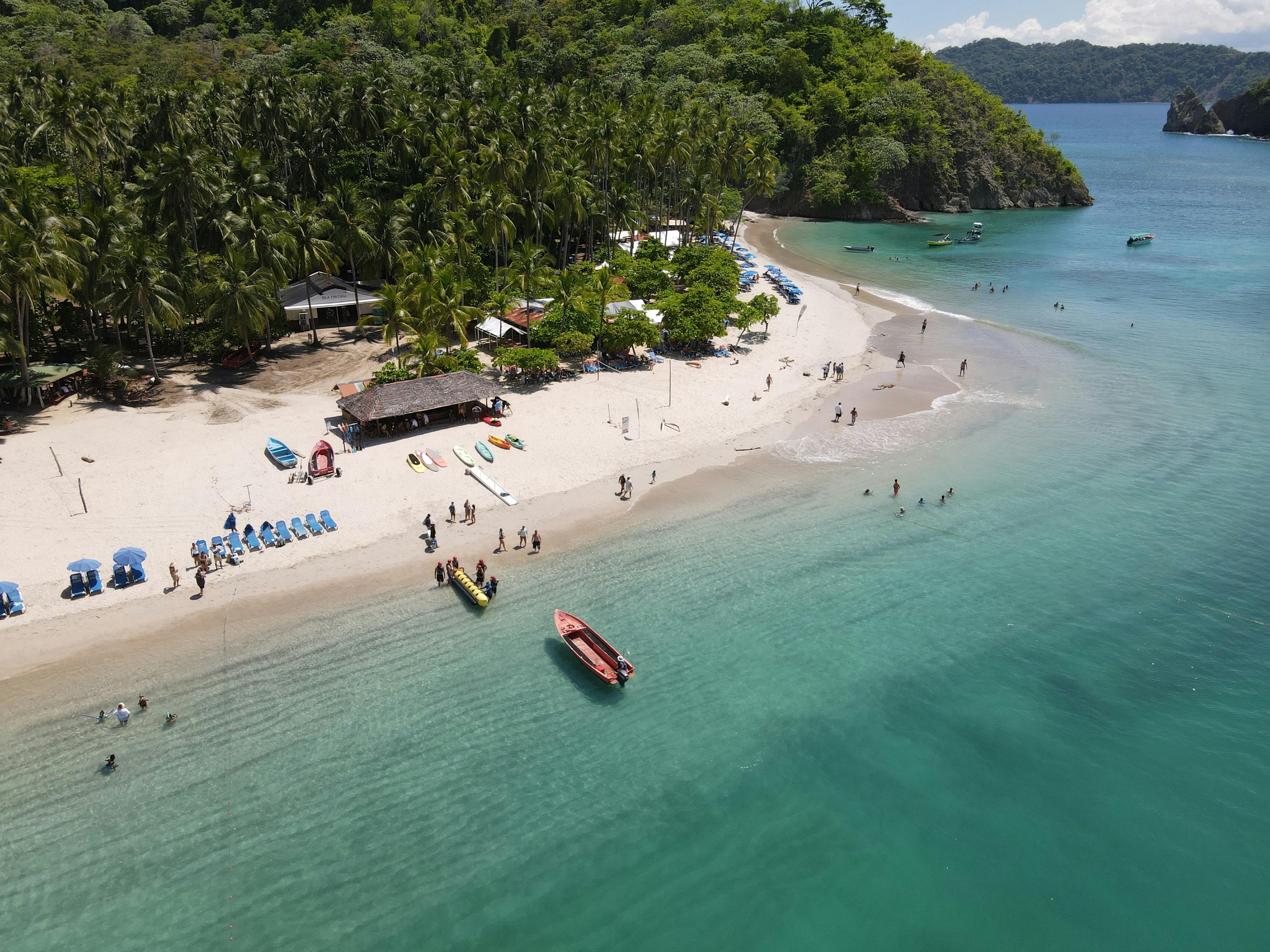Tropical beach in Philippines with white sand, turquoise water, and palm trees