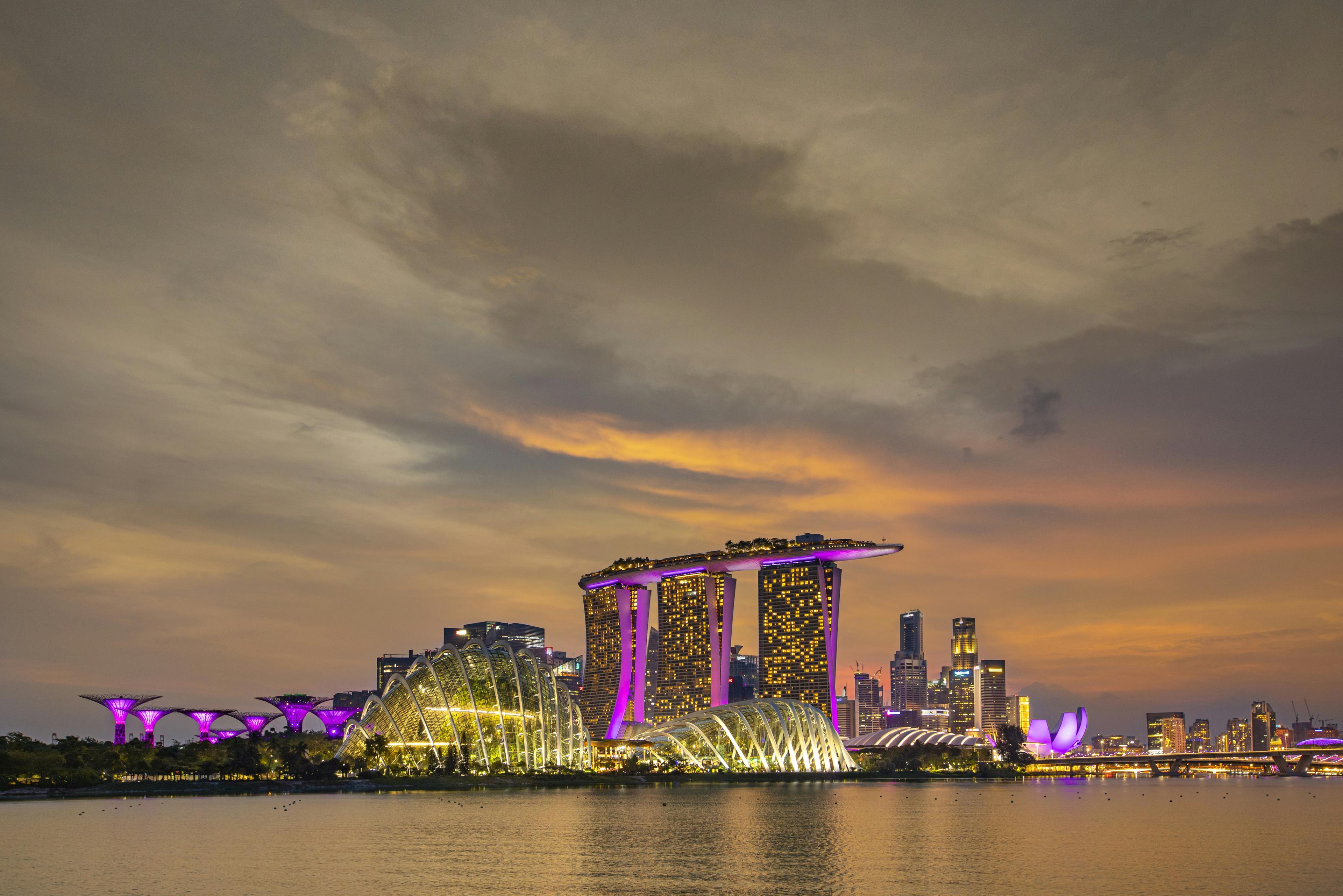 Modern Singapore skyline with Marina Bay Sands hotel and Gardens by the Bay at sunset